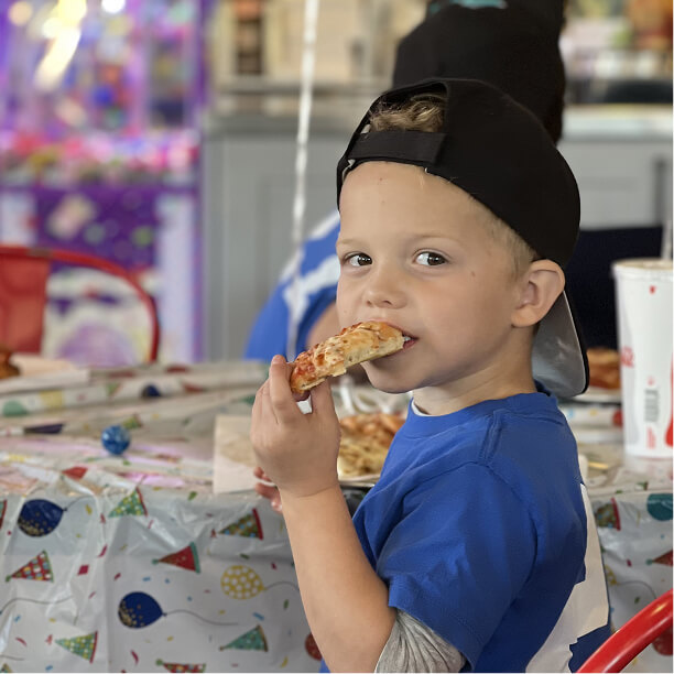 Child eating a slice of pizza